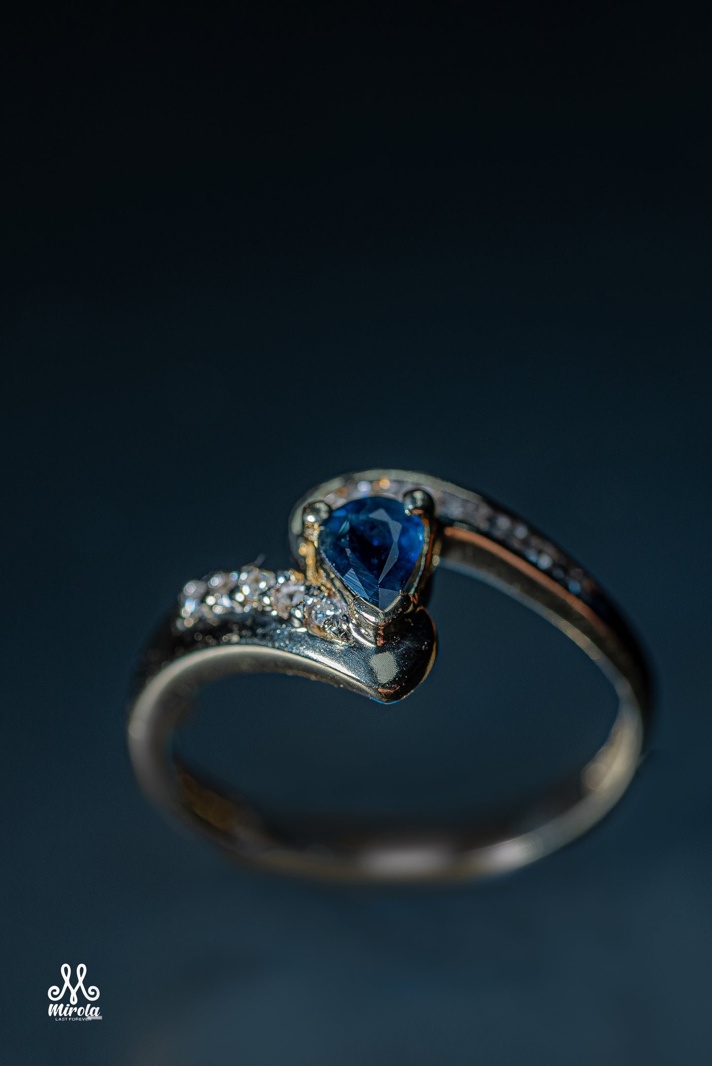 Diamond ring featuring a blue sapphire center stone