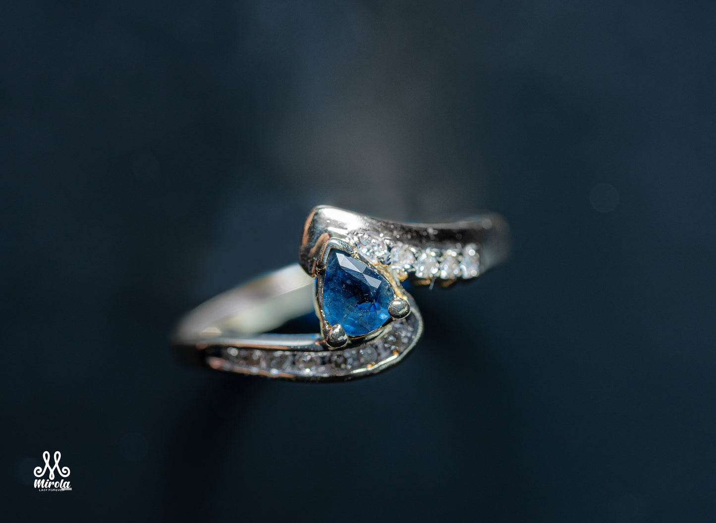 Diamond ring featuring a blue sapphire center stone