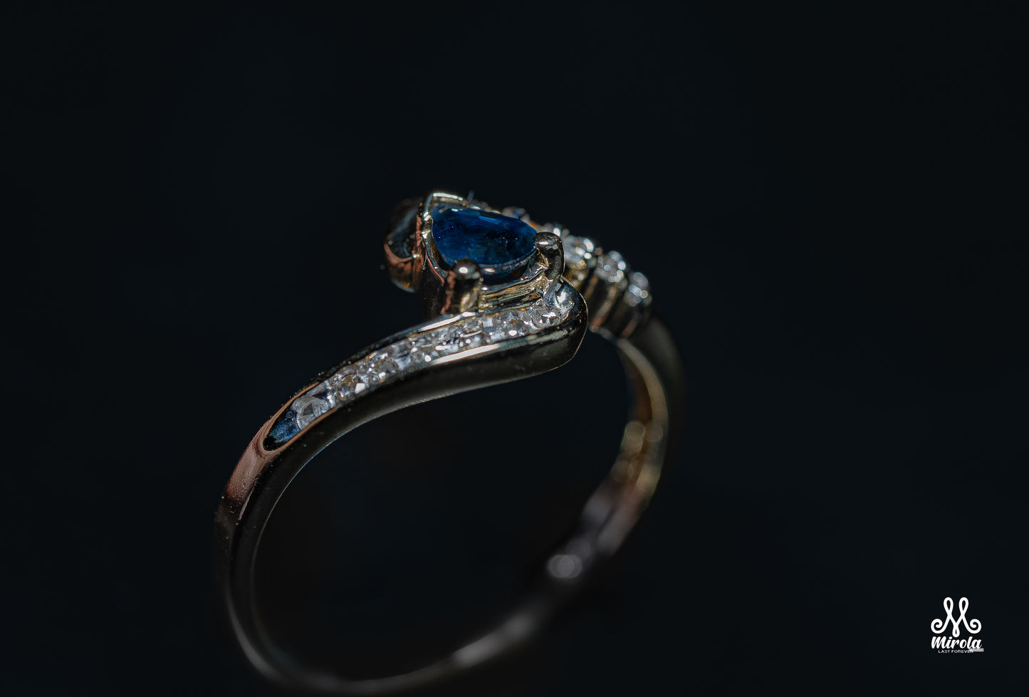 Diamond ring featuring a blue sapphire center stone