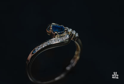 Diamond ring featuring a blue sapphire center stone