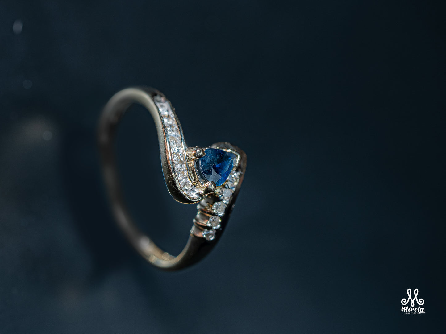 Diamond ring featuring a blue sapphire center stone